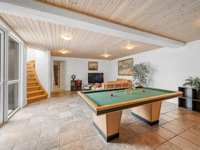 a living room with a pool table in it at Holiday Home Ginny - 300m to the fjord by Interhome in Struer