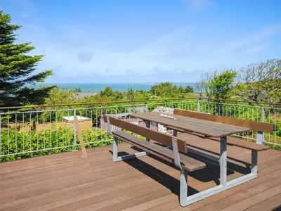 a wooden deck with a picnic table on a balcony at Holiday Home Ginny - 300m to the fjord by Interhome in Struer