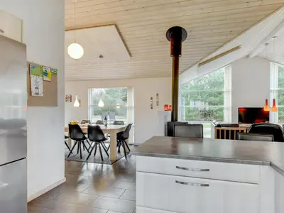 a kitchen and dining room with a table and chairs at Holiday Home Nani - 900m from the sea by Interhome in Torsted