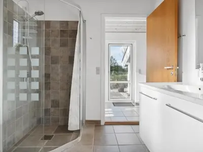a bathroom with a shower and a sink at Holiday Home Biriel - 1km from the sea by Interhome in Thisted