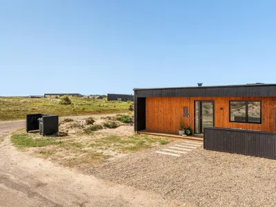 a house in the middle of a field at Holiday Home Trpana - 1-6km from the sea by Interhome in Thisted