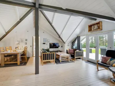 a living room with a conservatory with white ceilings at Holiday Home Hjalmara - 900m from the sea by Interhome in Thisted