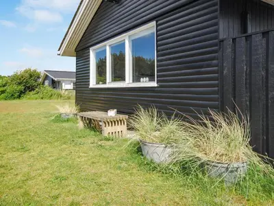 a black house with a window on the side of it at Holiday Home Engelbertine - 900m from the sea by Interhome in Thisted