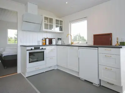 a white kitchen with white cabinets and a sink at Holiday Home Engelbertine - 900m from the sea by Interhome in Thisted