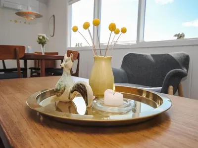 a table with a candle and two vases on it at Holiday Home Engelbertine - 900m from the sea by Interhome in Thisted
