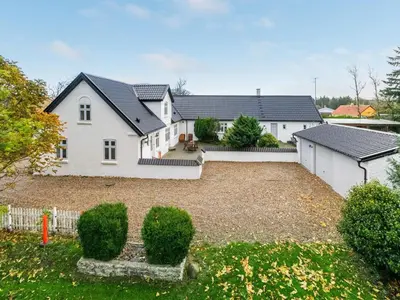 a large white house with a gravel yard at Holiday Home Sophia - 8km from the sea by Interhome in Thisted