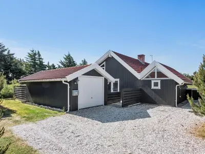 a house with a garage and a gravel driveway at Holiday Home Bente - 800m from the sea by Interhome in Thisted