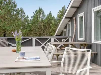 a patio with a table and chairs on a deck at Holiday Home Ljupka - 1km from the sea by Interhome in Thisted