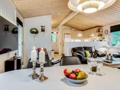 a kitchen and living room with a table with a bowl of fruit at Holiday Home Emeline - 1-7km from the sea by Interhome in Thisted