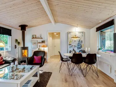 a living room with a table and chairs at Holiday Home Emeline - 1-7km from the sea by Interhome in Thisted