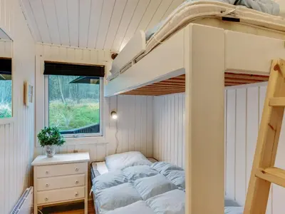 a bedroom with bunk beds in a tiny house at Holiday Home Emeline - 1-7km from the sea by Interhome in Thisted