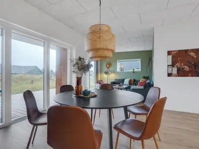 a dining room with a table and chairs at Holiday Home Kasper - 1-8km from the sea by Interhome in Thisted