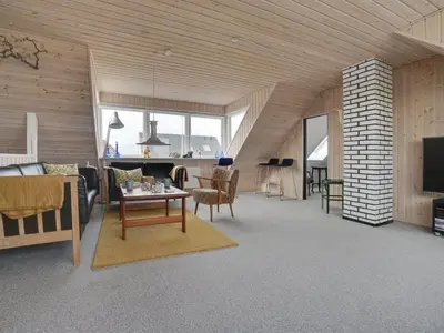 a living room with a couch and a table at Holiday Home Thilla - 100m from the sea by Interhome in Thisted