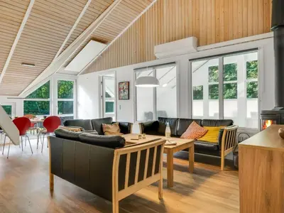 a living room with a couch and a table at Holiday Home Eisa - 300m to the fjord by Interhome in Øsløs