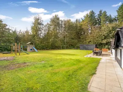 a large yard with a playground and a house at Holiday Home Eisa - 300m to the fjord by Interhome in Øsløs