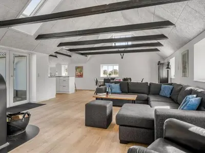 a living room with a couch and a table at Holiday Home Elisa - 1-2km from the sea by Interhome in Bedsted Thy