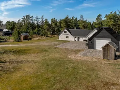 a large yard with a garage and a house at Holiday Home Elisa - 1-2km from the sea by Interhome in Bedsted Thy