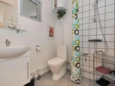 a bathroom with a toilet and a sink at Apartment Rejhana - 500m to the fjord by Interhome in Øsløs