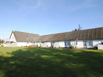 a large white house with a large yard at Apartment Rejhana - 500m to the fjord by Interhome in Øsløs