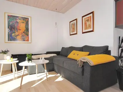 a living room with a couch and a table at Apartment Rejhana - 500m to the fjord by Interhome in Øsløs