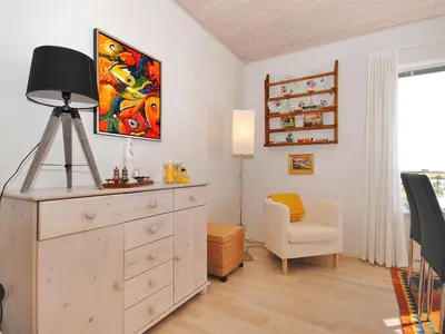 a room with a dresser with a lamp and a chair at Apartment Rejhana - 500m to the fjord by Interhome in Øsløs