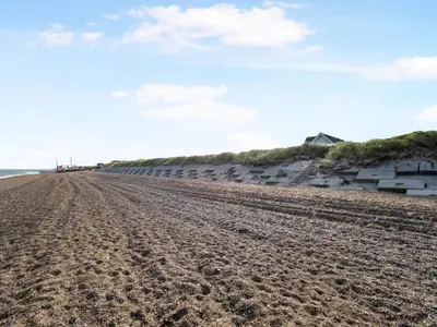 a beach with a row of beach huts at Holiday Home Ebba - 25m from the sea by Interhome in Frøstrup