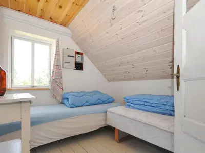 a room with two beds in a tiny house at Holiday Home Margrethe - 1-1km from the sea by Interhome in Bedsted Thy