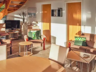a living room with chairs and a table and a tv at Holiday Home Simo - 250m from the sea by Interhome in Øsløs