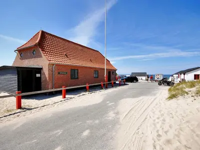 a building on the side of a road in the sand at Holiday Home Palle - 2km from the sea by Interhome in Snedsted