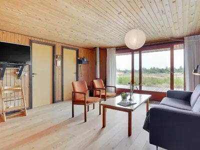 a living room with a couch and a table at Holiday Home Atreju - 2km from the sea by Interhome in Bedsted Thy