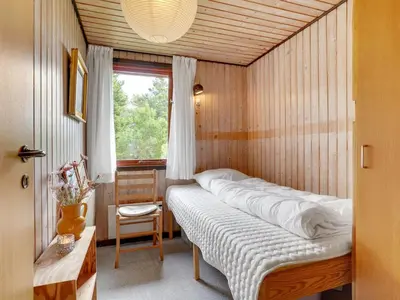 a bedroom with a bed in a room with a window at Holiday Home Atreju - 2km from the sea by Interhome in Bedsted Thy