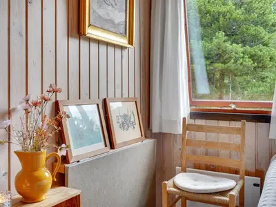 a room with two pictures and a vase and a window at Holiday Home Atreju - 2km from the sea by Interhome in Bedsted Thy