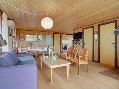 a living room with a couch and a table at Holiday Home Atreju - 2km from the sea by Interhome in Bedsted Thy
