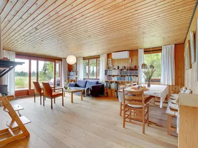 a living room with a wooden ceiling at Holiday Home Atreju - 2km from the sea by Interhome in Bedsted Thy