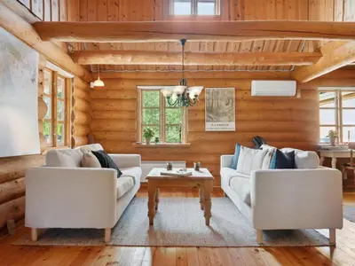a living room with two couches and a table at Holiday Home Elsia - 1-5km to the fjord by Interhome in Frøstrup