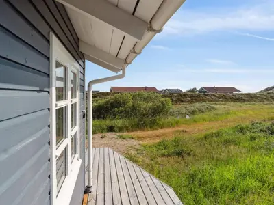 a porch of a house with a view of a field at Holiday Home Wulfhard - 400m from the sea by Interhome in Frøstrup