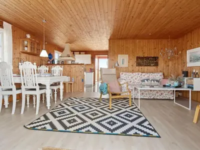 a living room with a couch and a table at Holiday Home Wulfhard - 400m from the sea by Interhome in Frøstrup