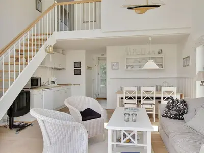 a living room with a couch and a table at Apartment Hubertine - 100m to the fjord by Interhome in Vestervig