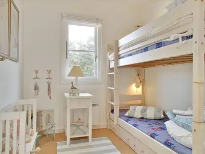 a bedroom with two bunk beds and a desk at Apartment Hubertine - 100m to the fjord by Interhome in Vestervig