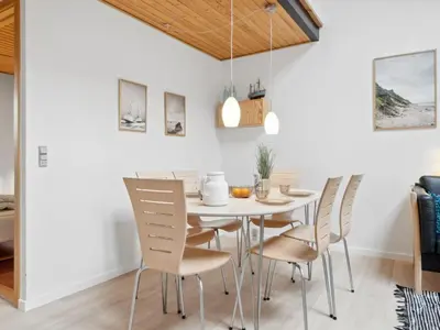 a dining room with a white table and chairs at Apartment Dineke - 200m to the fjord by Interhome in Vestervig