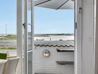 a door to a patio with a view of the ocean at Apartment Siunde - 100m to the fjord by Interhome in Vestervig