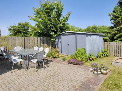 a patio with a table and chairs and a fence at Holiday Home Gertina - 40m to the fjord by Interhome in Vestervig