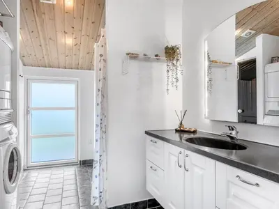a kitchen with white cabinets and a sink at Holiday Home Selke - 300m to the fjord by Interhome in Vestervig