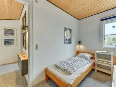 a bedroom with a bed and a window at Apartment Cita - 100m to the fjord by Interhome in Vestervig