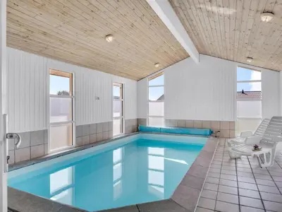 a swimming pool with blue water in a house at Holiday Home Sulevi - 200m to the fjord by Interhome in Vestervig