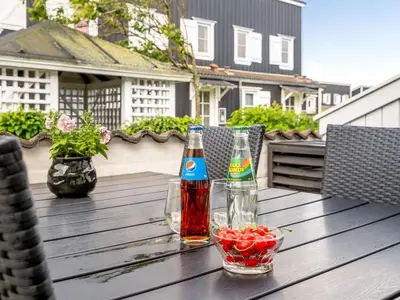 two bottles of soda and a bowl of fruit on a wooden table at Apartment Hermanda - 100m to the fjord by Interhome in Vestervig