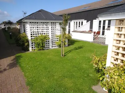 a yard with a tree in the middle of a building at Apartment Hermanda - 100m to the fjord by Interhome in Vestervig