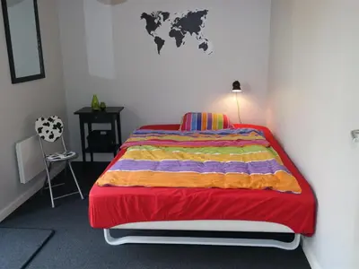 a bedroom with a bed with a world map on the wall at Holiday Home Assarina - 300m to the fjord by Interhome in Vinderup