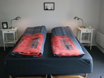 a bed with two pillows on it with two tables at Holiday Home Assarina - 300m to the fjord by Interhome in Vinderup