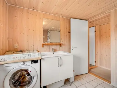 a kitchen with a washing machine and a sink at Holiday Home Scarlet - 400m to the fjord by Interhome in Vinderup